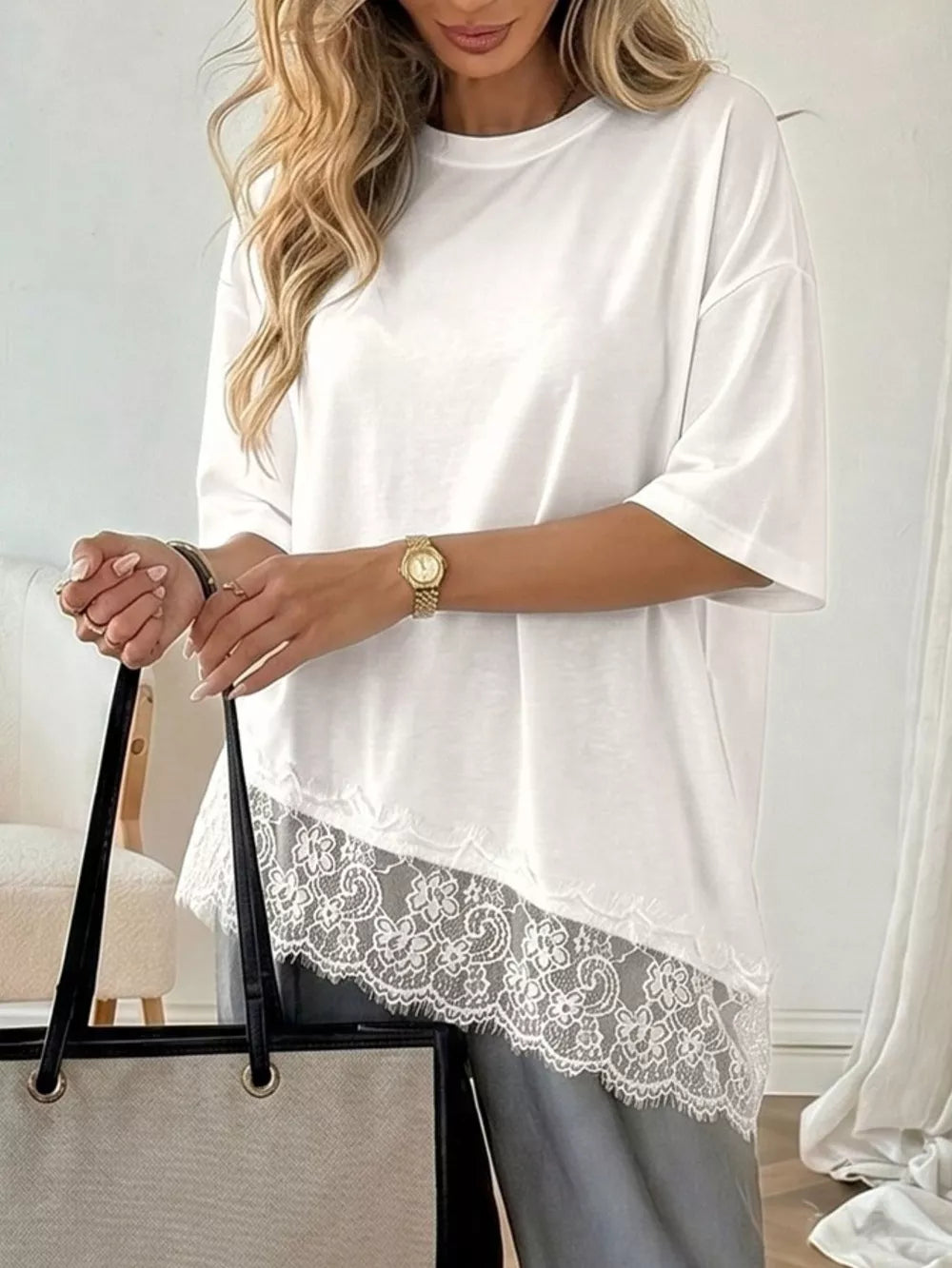 White tee with lace trim hem and half sleeves, asymmetrical cut.