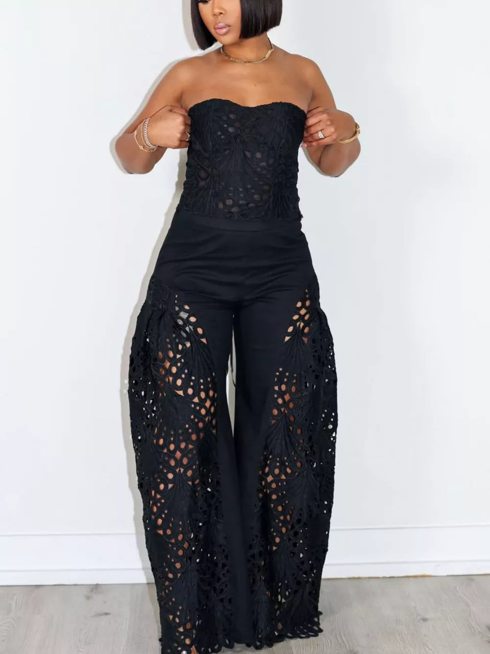 Black lace cutout tube top and wide-leg pants set with airy detailing.