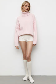 Oversized blush pink turtleneck knit sweater with ribbed cuffs and hem.