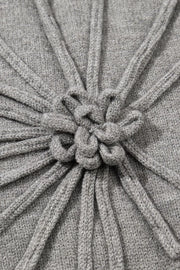 Gray knit blouse with a central embroidered bloom detail and ribbed texture.