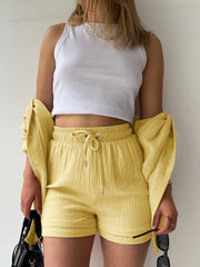 Textured gauze shirt and short co-ord set in blush pink, casual button-up style.