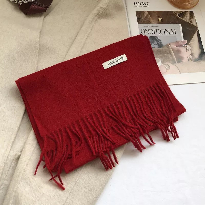 Luxurious wool knit scarf in Christmas Red with fringes and a 100% wool tag.
