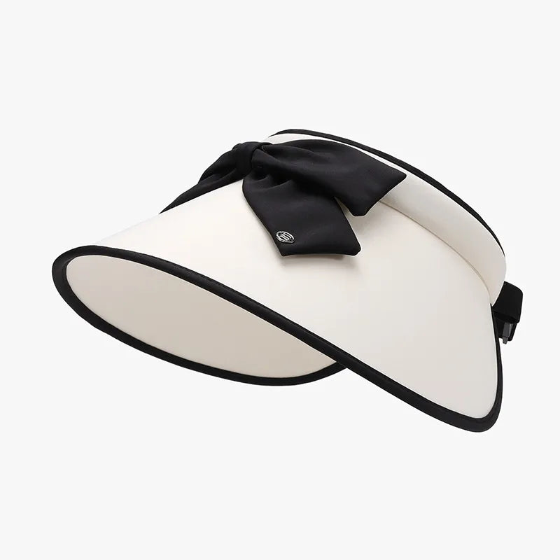 Ivory sun visor with black contrast trim and bow detail