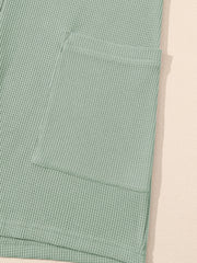 Sage waffle knit button-down romper with a chest pocket detail.