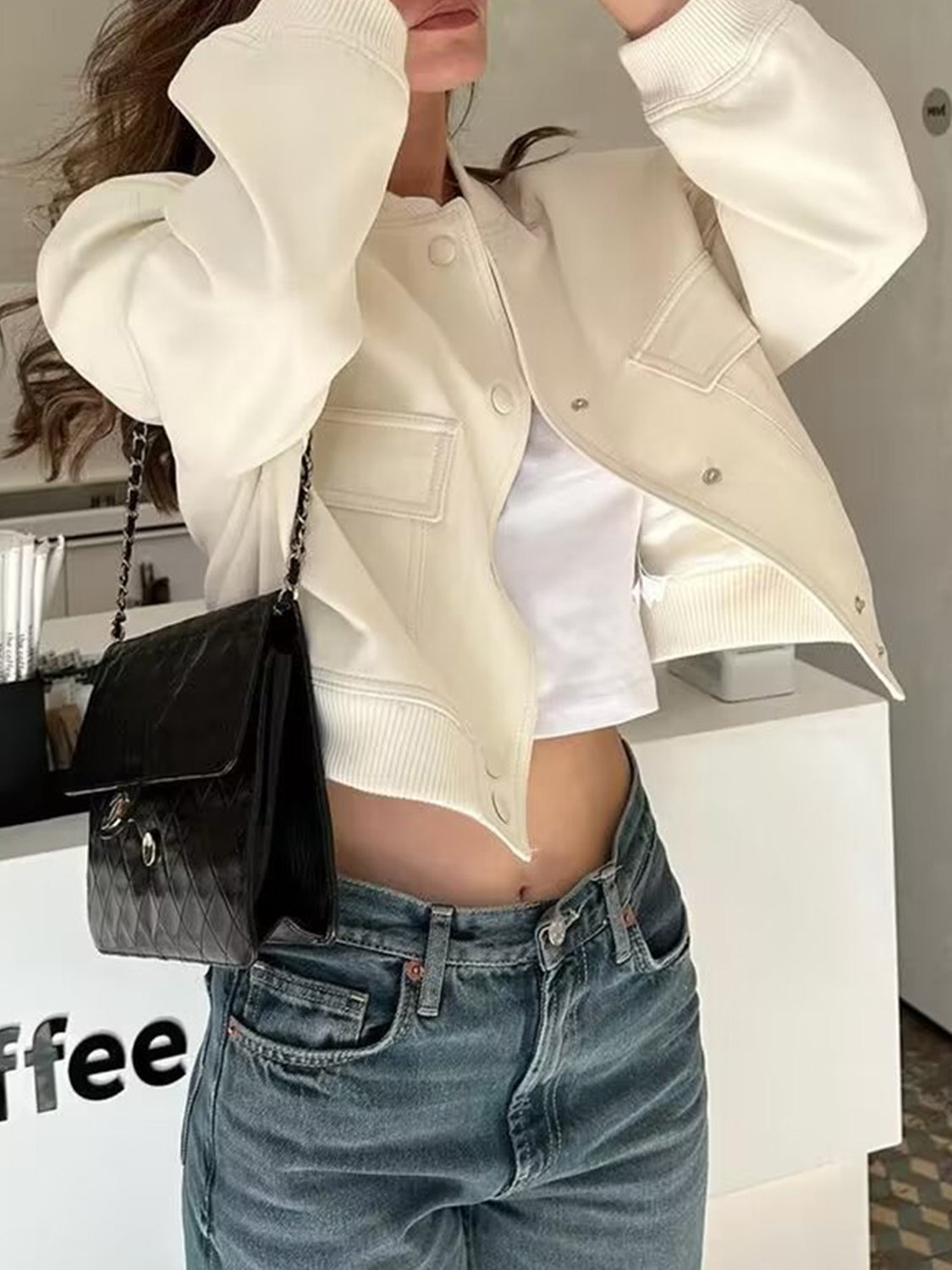 Cream utility pocket bomber jacket with buttoned front and ribbed cuffs.