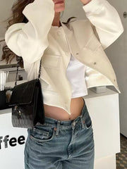 Cream utility pocket bomber jacket with buttoned front and ribbed cuffs.