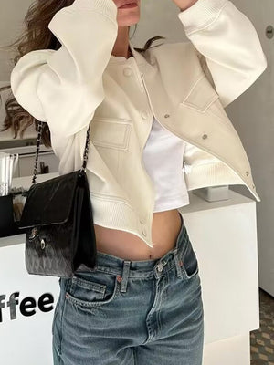 Cream utility pocket bomber jacket with buttoned front and ribbed cuffs.