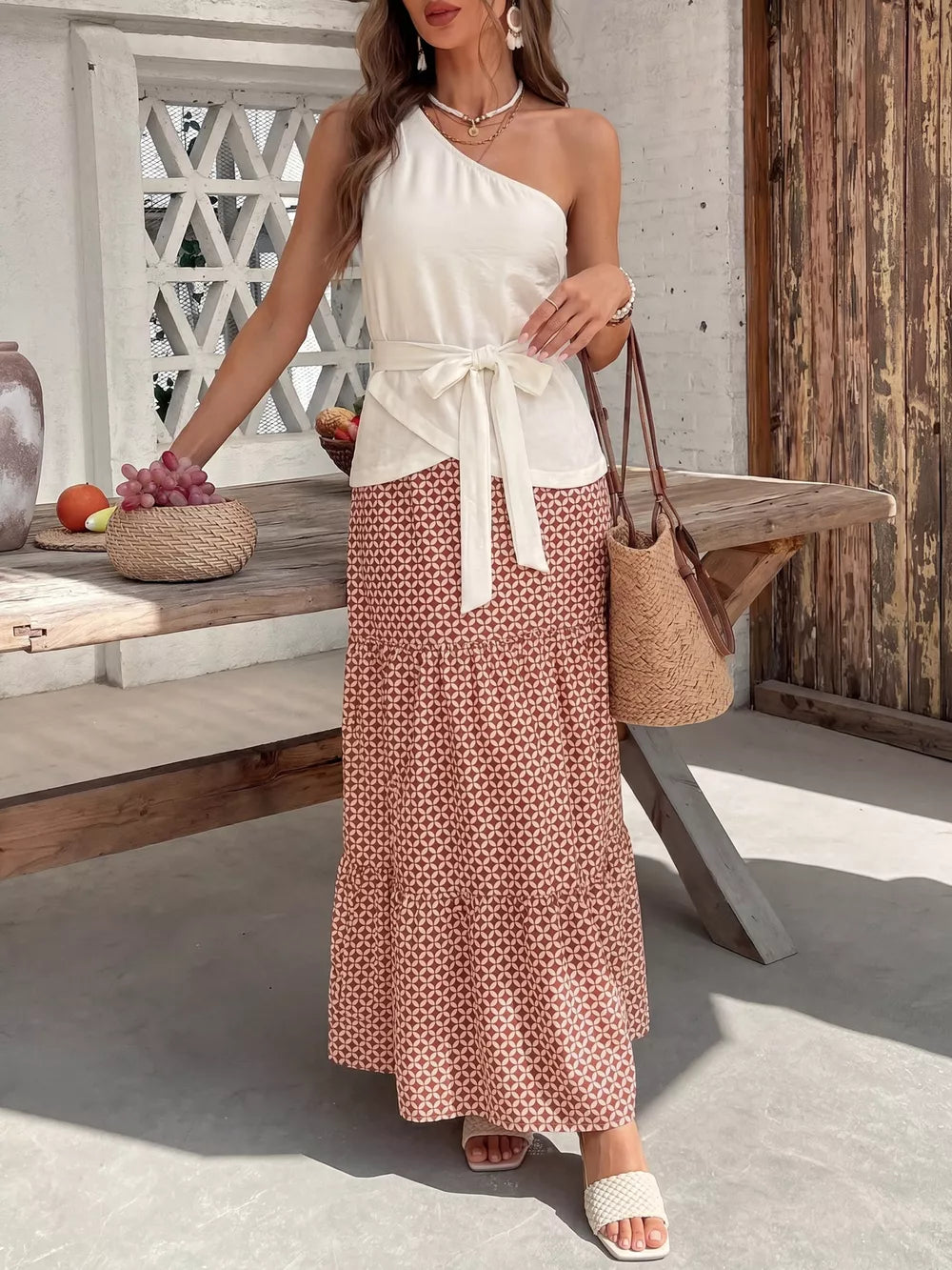 Cream one-shoulder top with tie waist and geometric print maxi skirt set