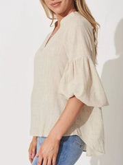 Maternity shirt in beige linen-blend with notched V-neck and balloon sleeves.