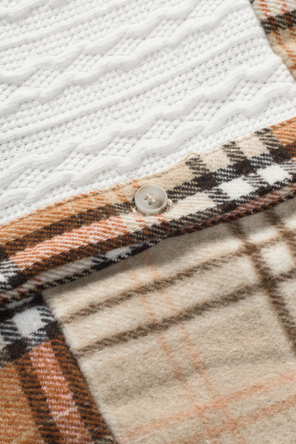 Patchwork plaid knit shacket in sherbet with cable knit detail and button closure.