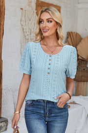 Light blue perforated puff sleeve henley blouse with button detail and eyelet pattern.