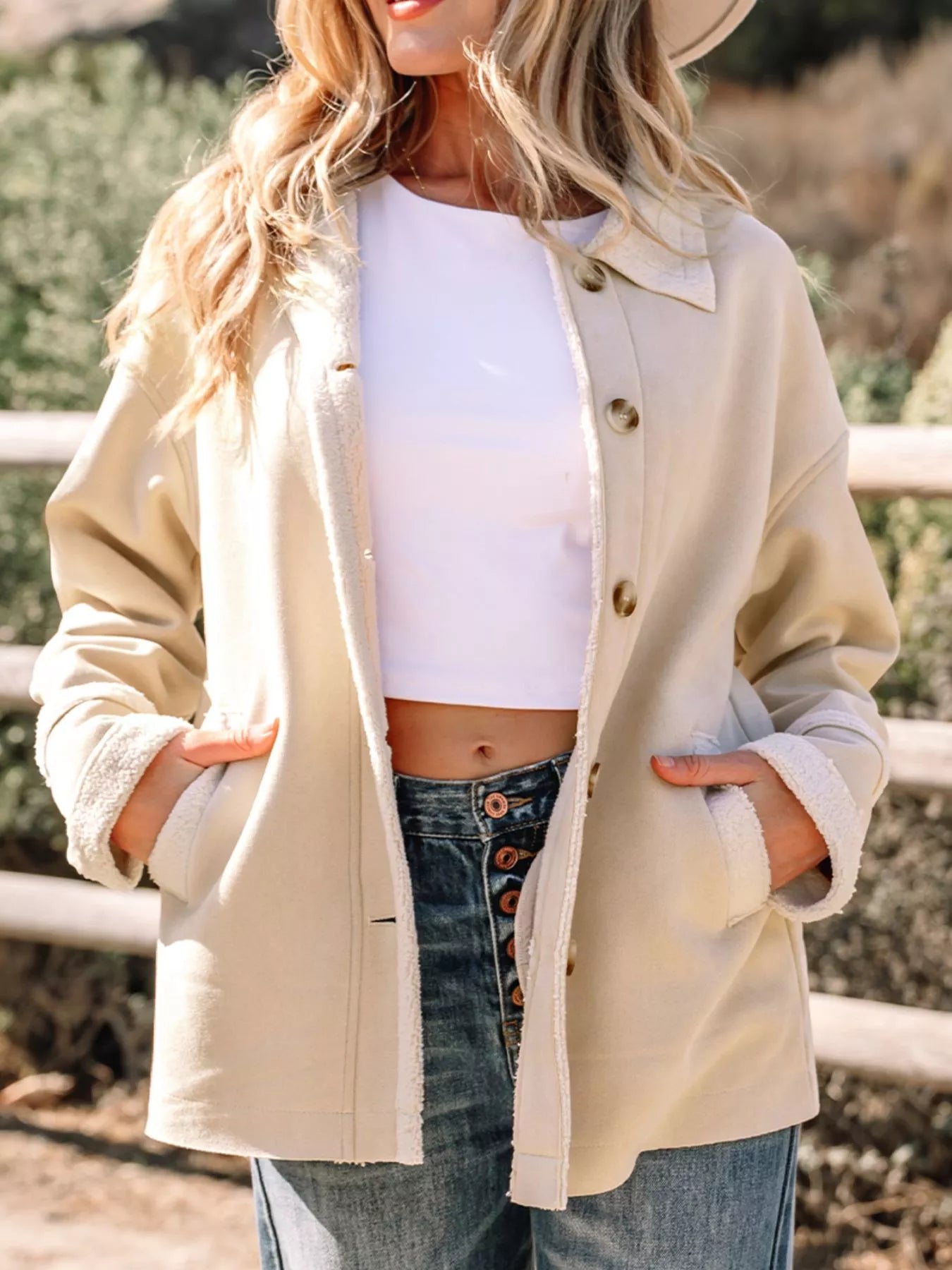 Lined Western jacket in eggshell with button front and sherpa trim cuffs.