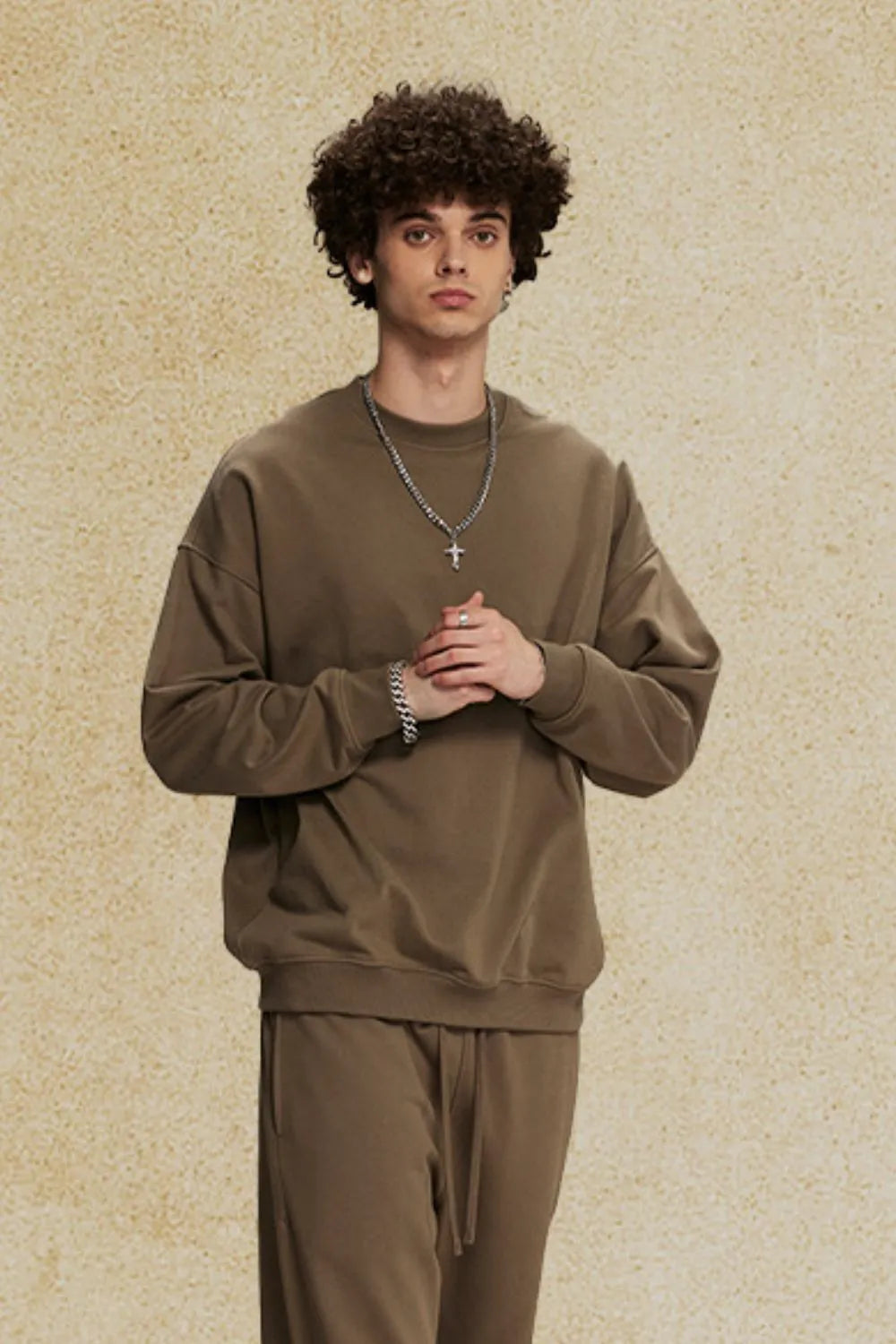 Oversized crewneck sweatshirt in tan with subtle shoulders and ribbed cuffs and hem.