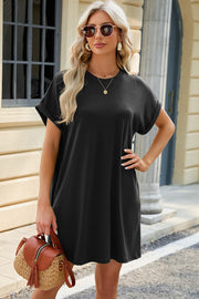 Black cuffed sleeve pocket dress with crew neck and relaxed fit