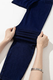 Dark denim jeggings with faux pockets, showing stretch fabric detail.