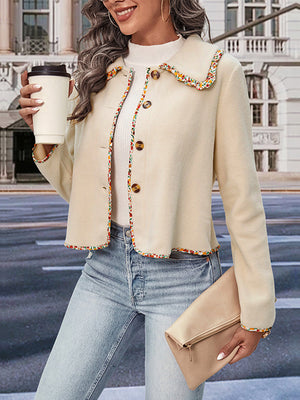 Cream bolero jacket with floral trim and scalloped collar, buttoned front.