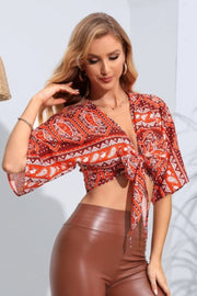 Paisley print knot-front crop blouse with flutter sleeves in multicolor.