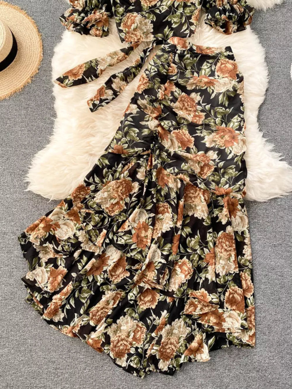 Chic floral two-piece crop set in black with ruffled skirt and tie-front top.