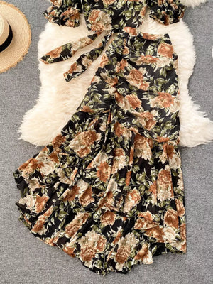 Chic floral two-piece crop set in black with ruffled skirt and tie-front top.