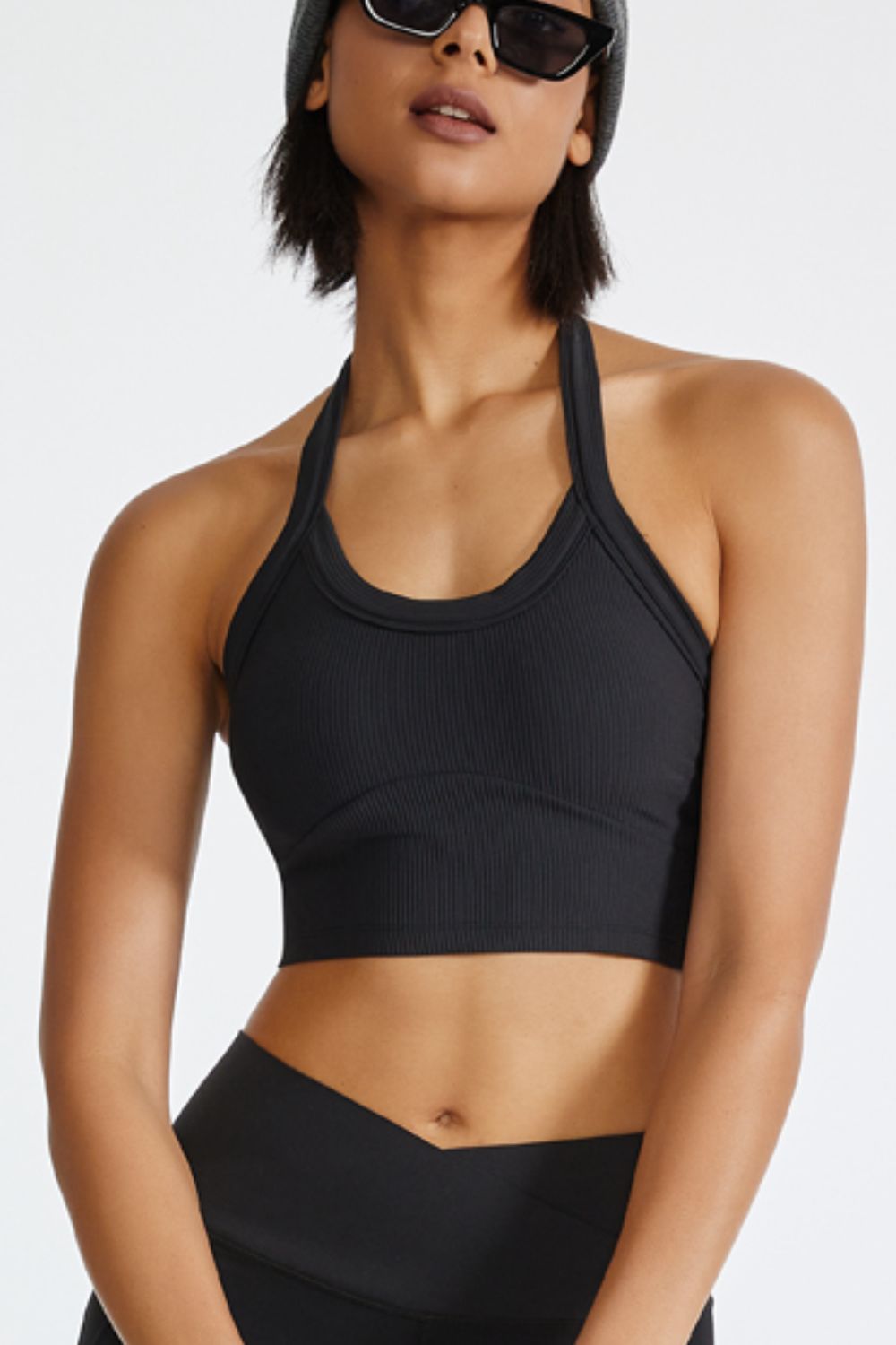 Black ribbed halter crop top with a U-neckline and cropped length.