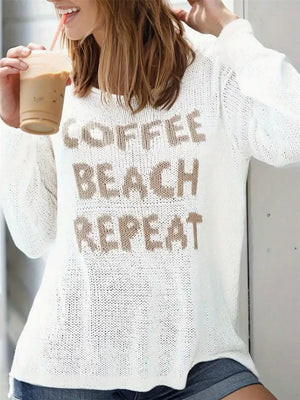 White knit sweater with "COFFEE BEACH REPEAT" graphic and side slits.