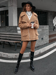 Camel teddy moto jacket with asymmetrical zip and collared neckline.