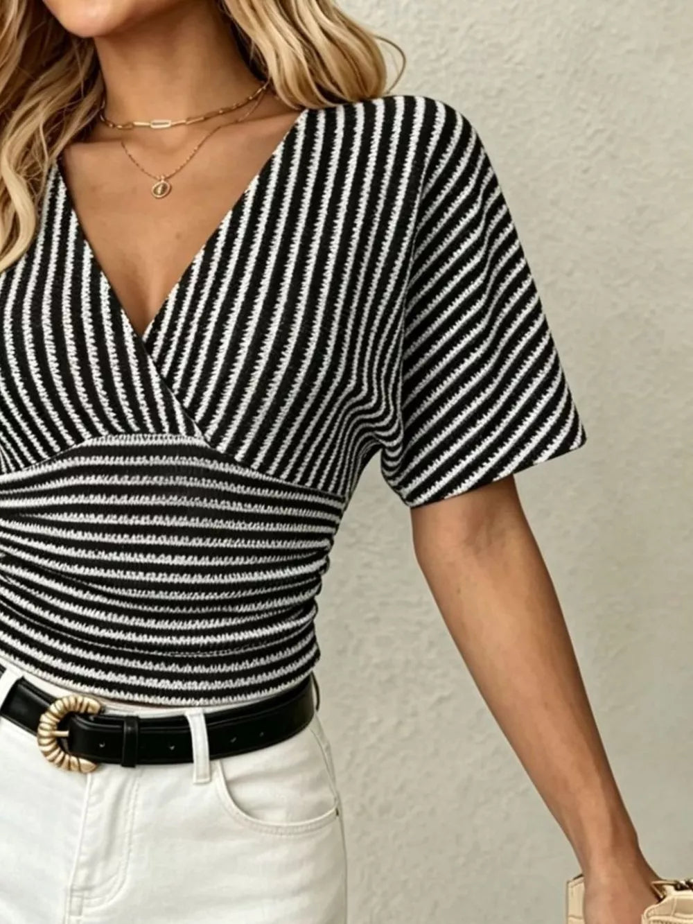 Chic striped black and white surplice t-shirt with smocked waist and batwing sleeves.