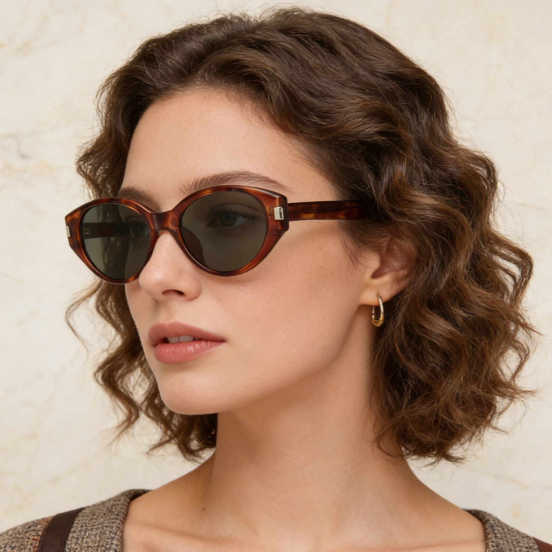 Tortoiseshell cat-eye sunglasses with dark lenses and acetate frames.