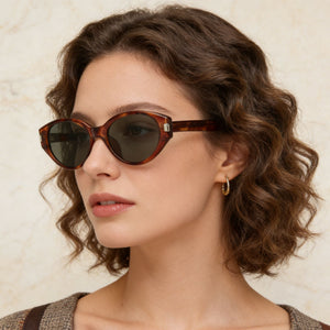 Tortoiseshell cat-eye sunglasses with dark lenses and acetate frames.