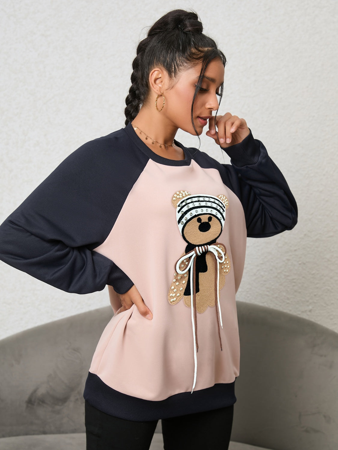 Blush pink raglan sweatshirt with teddy bear appliqué and beaded details.