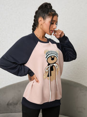 Blush pink raglan sweatshirt with teddy bear appliqué and beaded details.