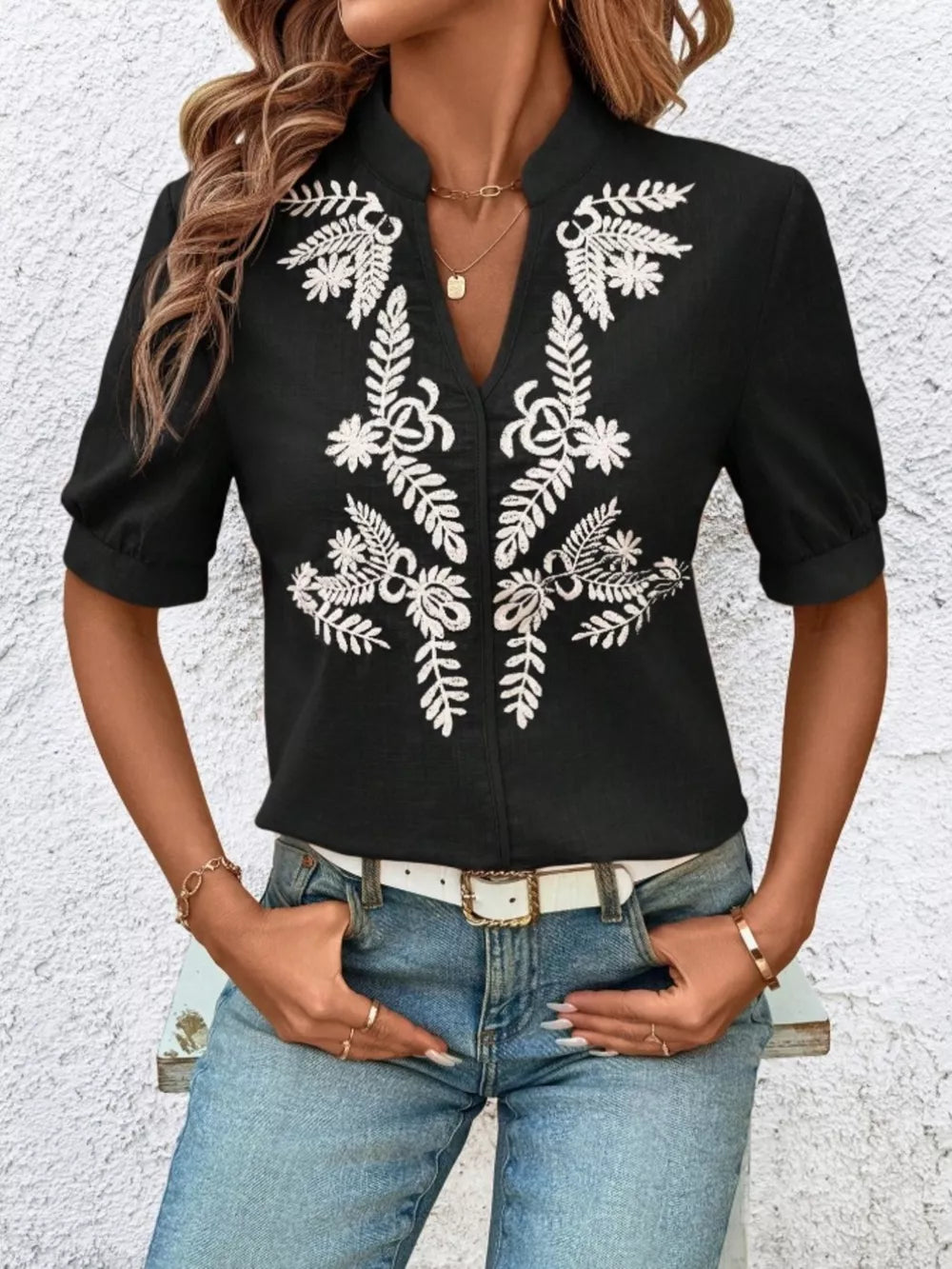 Black embroidered notched blouse with cuffed sleeves and V-neck.