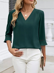 Dark green V-neck blouse with 3/4 sleeves and lace trim detail.