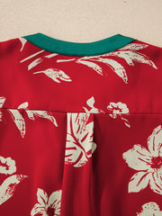 Red floral print blouse with green trim and pleat detail