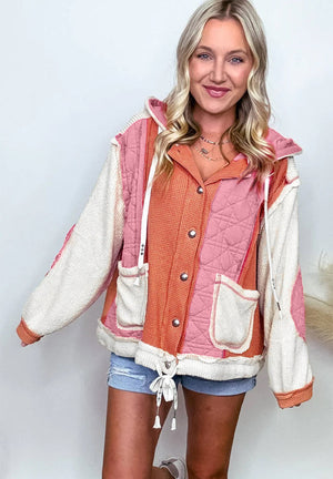 Colorblock quilted hooded waffle jacket in dusty pink with contrast waffle knit and drawstring hem.