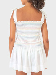 White outfit set with rainbow smocked bodice and tie straps, and a ruffled hem skirt.