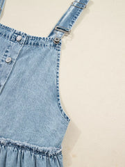 Light blue denim tiered overall dress with button front and ruffled hem detail.