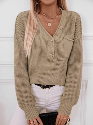 Relaxed knit sweater in olive green with button detail and chest pocket, V-neck, long sleeves.