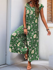 Dark green botanical print culotte jumpsuit with short sleeves and a round neckline.