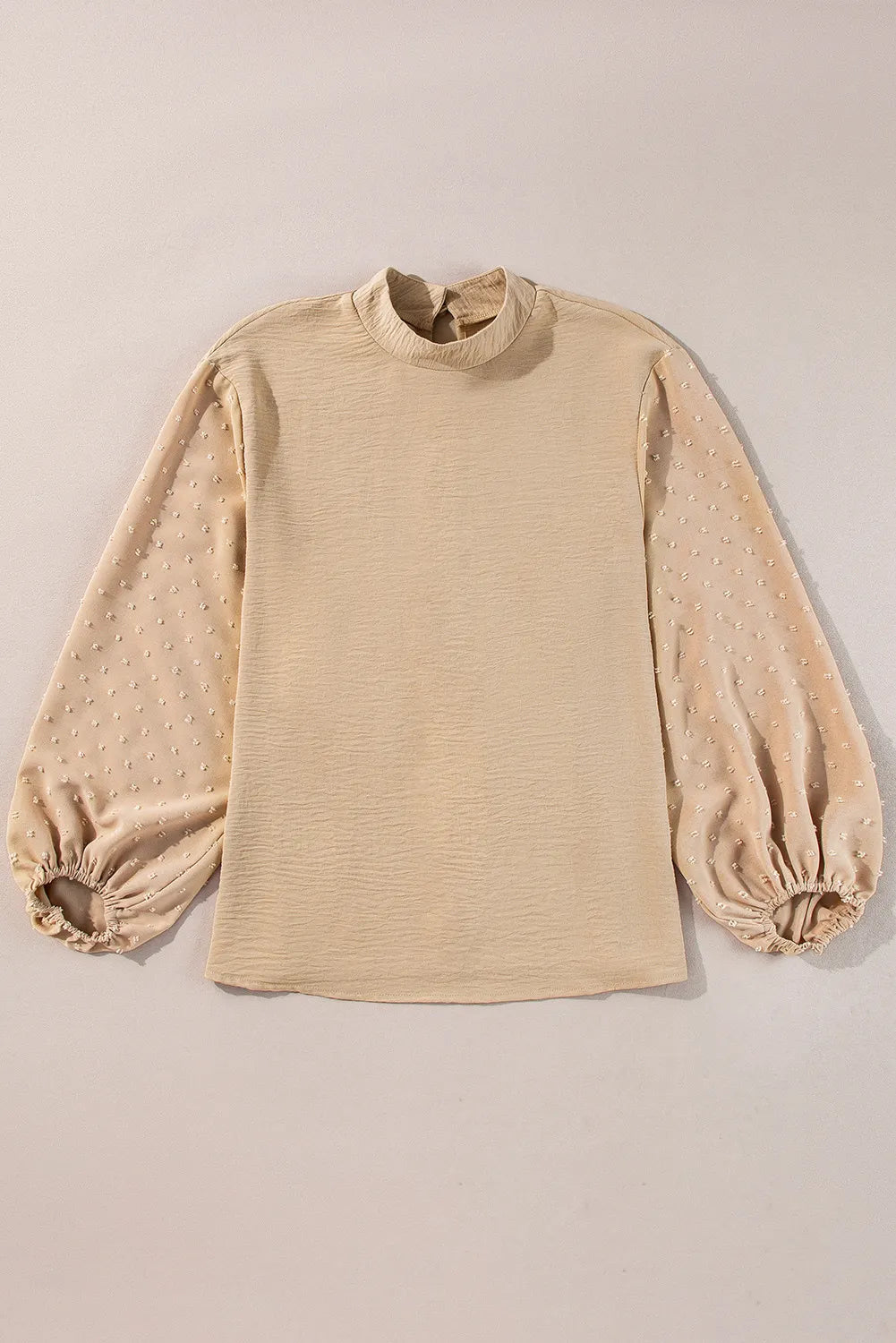 Tan textured blouson top with Swiss dot puff sleeves and mock neck.