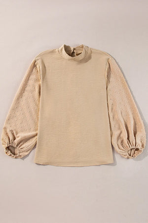 Tan textured blouson top with Swiss dot puff sleeves and mock neck.