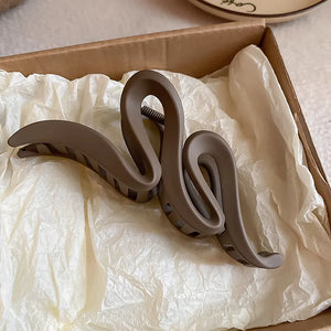 Sculptural hair claw in Coffee Brown acrylic with serpentine design