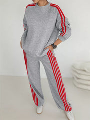 Grey two-piece loungewear set with red stripes on sleeves and pants.