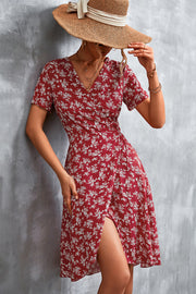 Crimson floral wrap midi dress with short sleeves and a V-neck, styled with a straw hat.