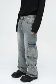 Medium wash denim cargo pants with multiple utility pockets and wide legs.