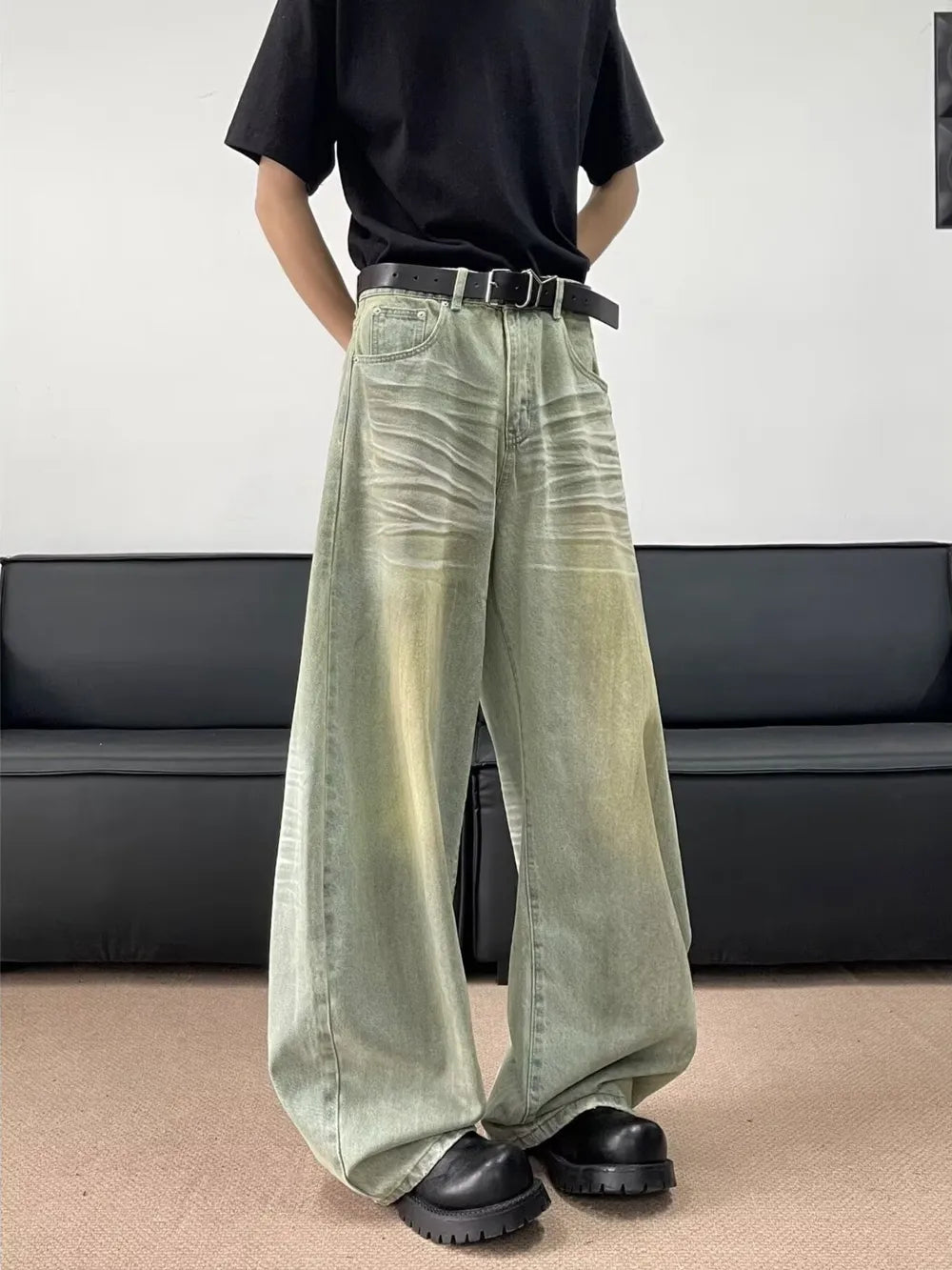 Lived-in oversized men's jeans in light blue with creasing and a relaxed fit.