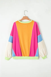 Colorblock paneled sweatshirt with neon trim, featuring bright pink, orange, cream, and blue panels.