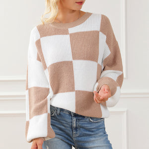 Checkerboard knit drop shoulder pullover sweater in tan and white acrylic with crew neck and balloon sleeves.