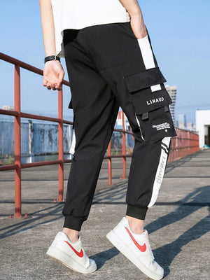 Black cargo joggers with white side stripes and cuffed ankles.