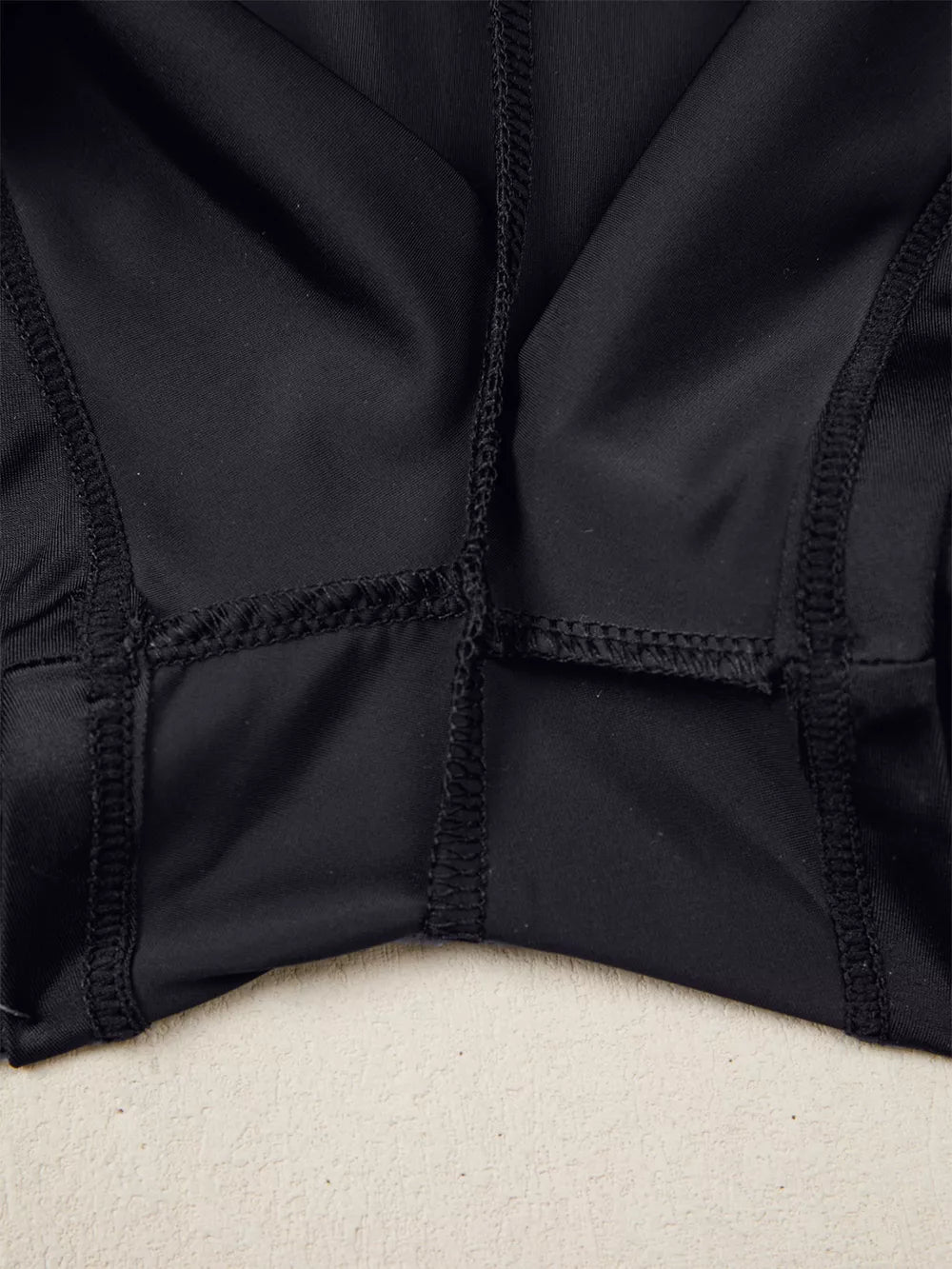 Black athletic jogger shorts with visible seams and ribbed waistband detail.